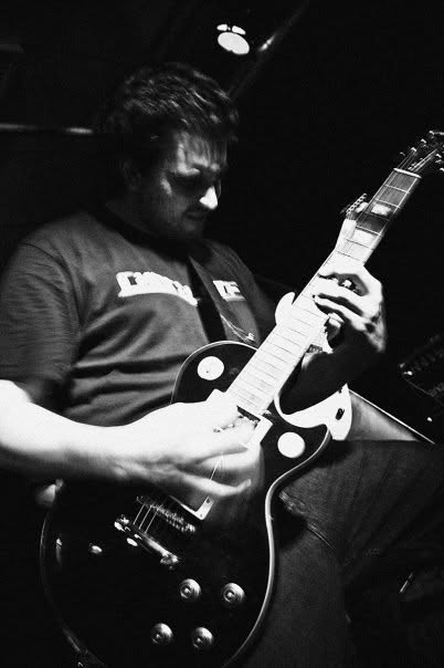 Content creator testing a modern custom guitar in a recording studio